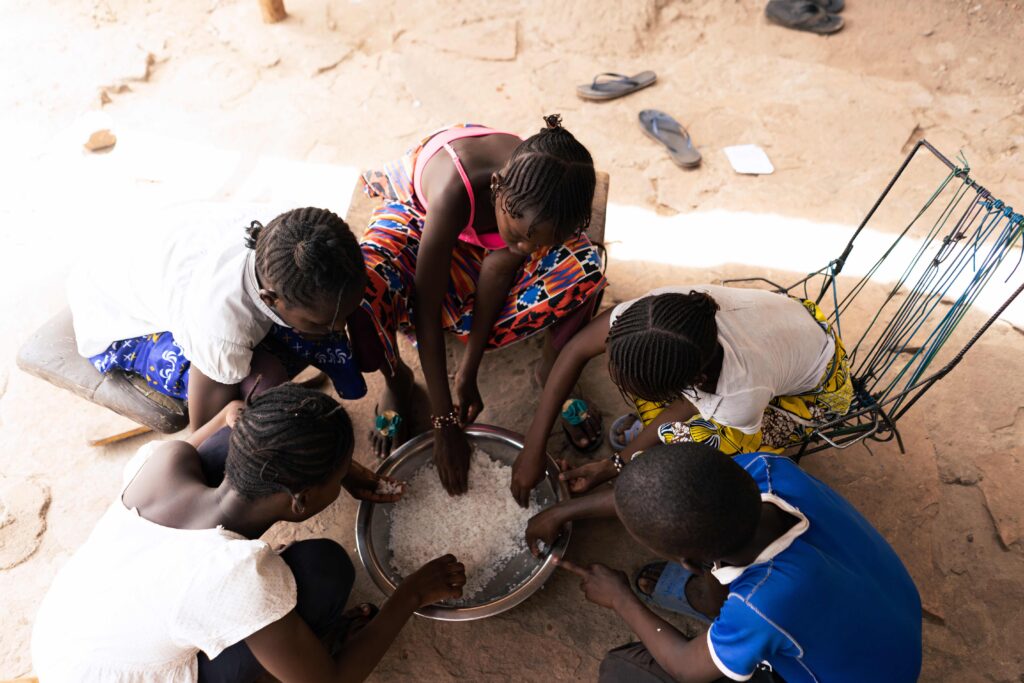 Overhead view of a group of African village children sharing a simple meal of rice; malnutrition concept